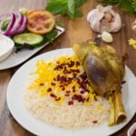 Qabuli palow with tender lamb shank, carrots, and raisins