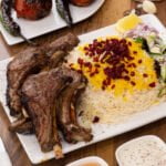 Tender and juicy lamb chops with fragrant palow rice. Famous afghan cuisine cooked in afghani style.